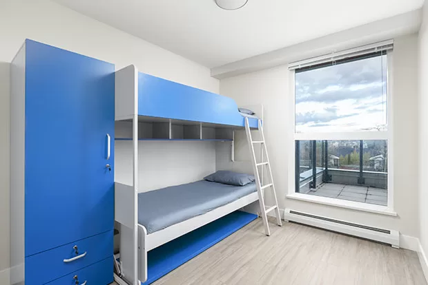 Economy Shared Bedroom at GEC Pearson student housing features one bunk bed for two students