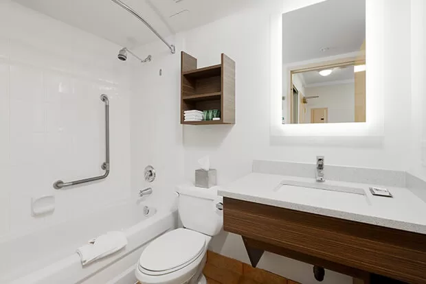 Downtown Vancouver GEC Granville Suites long term extended stays hotel has an ensuite bathroom with bathtub, standing shower, and complimentary toiletries