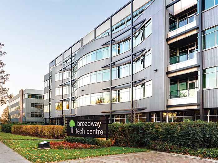 Exterior shot of the Broadway tech centre, with a glimpse of the sidewalk and green grass area next to it