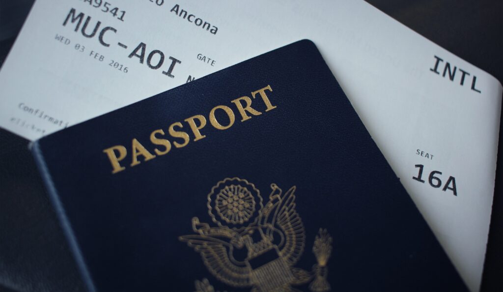 A dark blue-covered passport with a flight ticket in it. It is one of the important item on checklist to Vancouver