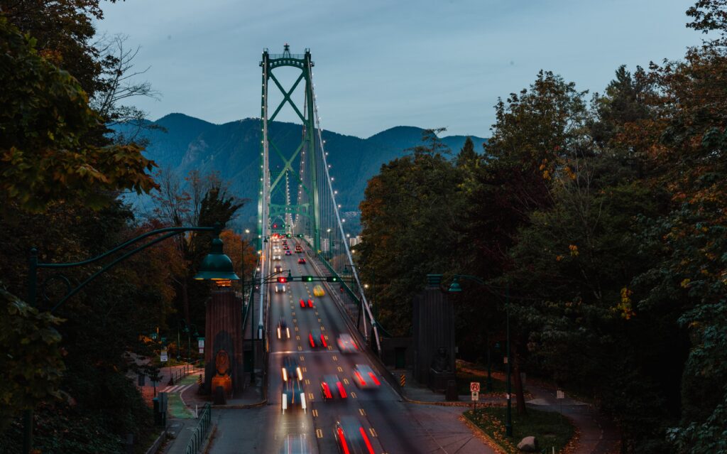 image of a bridge with cars going across it, the cars look blurry and in motion